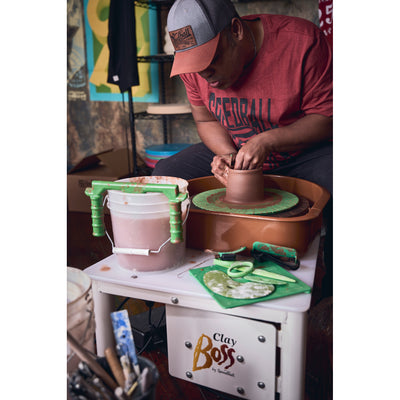 Potter throwing on a Speedball Clay Boss Pottery Wheel with tools and bucket - Soul Ceramics